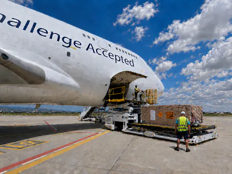 Palletised cargo prepared beside a cargo aircraft