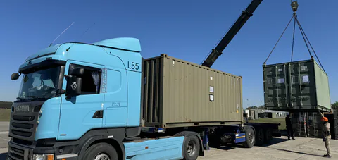 Container being loaded onto a road freight vehicle